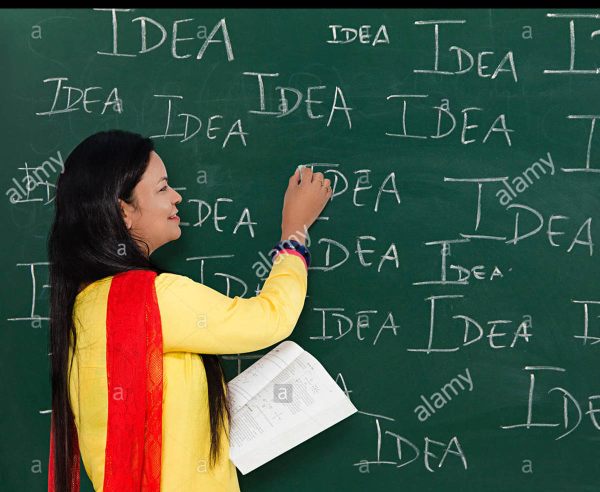 1-indian-adult-woman-teacher-writing-blackboard-FDDDGJ